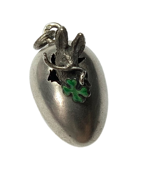 Silver pendant with rabbit and clover design on a white background